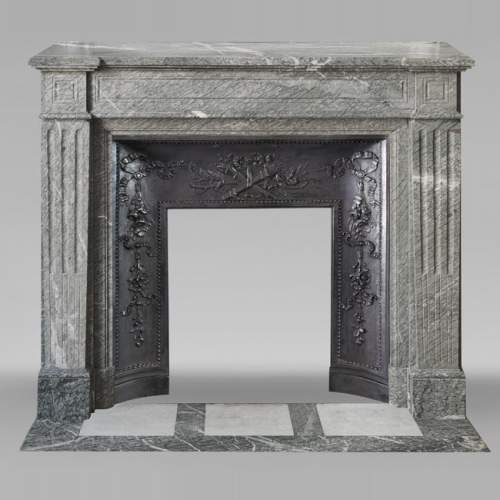 Louis XVI style fireplace with molded decoration, in green Campan marble
