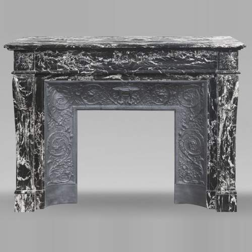 Louis XVI style fireplace decorated with a flower, in black Marquina marble