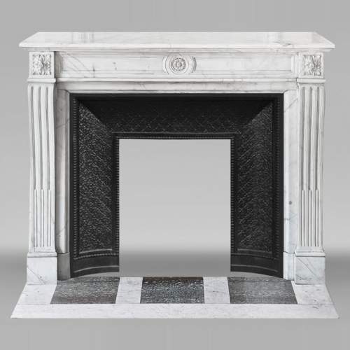 Louis XVI style fireplace in semi-statuary marble, decorated with a sunflower