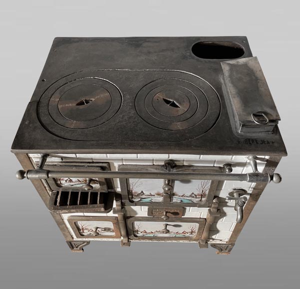 Cast-iron stove with faience imitation and snowy landscape decoration-1