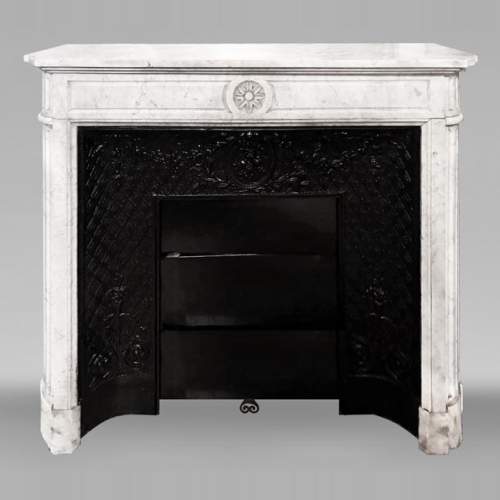 Louis XVI style fireplace with rounded corners, decorated with a daisy, in Carrara marble