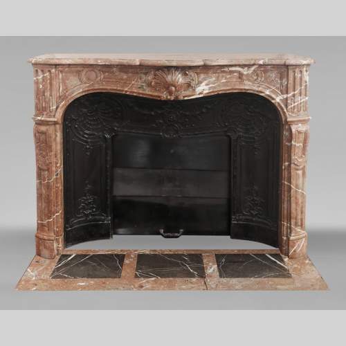 Louis XV style fireplace decorated with a palmette, in Northern Red marble