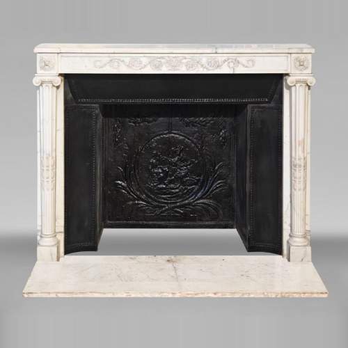 Louis XVI style fireplace in semi-statuary marble, featuring columns and Ionic capitals