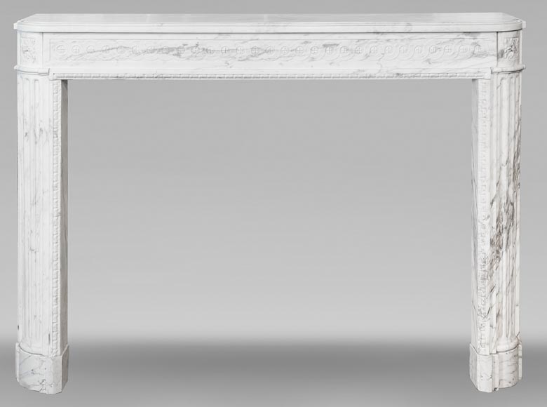 A Louis XVI period fireplace in veined Carrara marble, decorated with a Greek-style frieze. A Louis XVI period fireplace in veined Carrara marble, decorated with a Greek-style frieze.-0