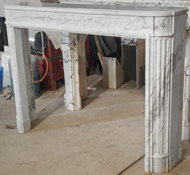 A Louis XVI period fireplace in veined Carrara marble, decorated with a Greek-style frieze. A Louis XVI period fireplace in veined Carrara marble, decorated with a Greek-style frieze.-6