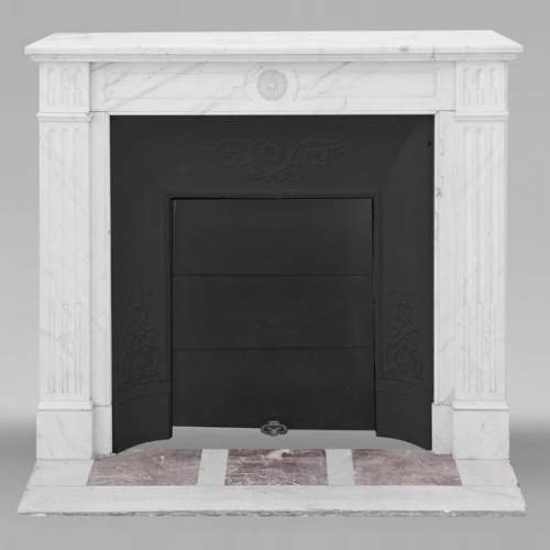 Louis XVI style fireplace in semi-statuary marble, decorated with a sunflower