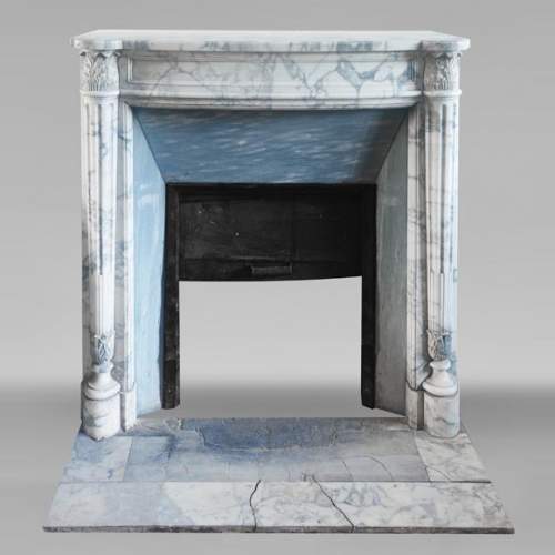 Louis XVI style curved-front fireplace in Arabescato marble, featuring half-columns of the Corinthian order