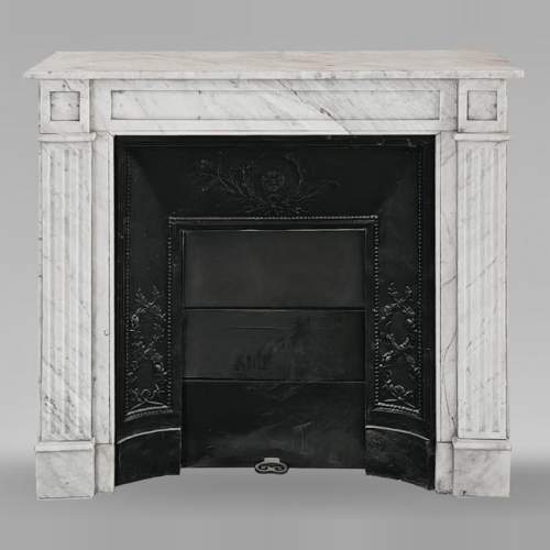 Louis XVI-style fireplace in Carrara marble, featuring molded ornamentation